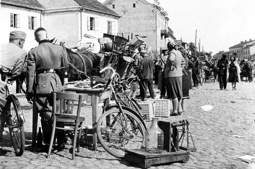 German policemen examining the property of Jews being deported from Szydłowiec.