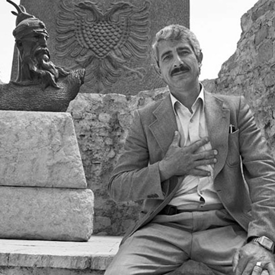 Enver Alia Sheqer with statue of Albania's national hero Skanderbeg