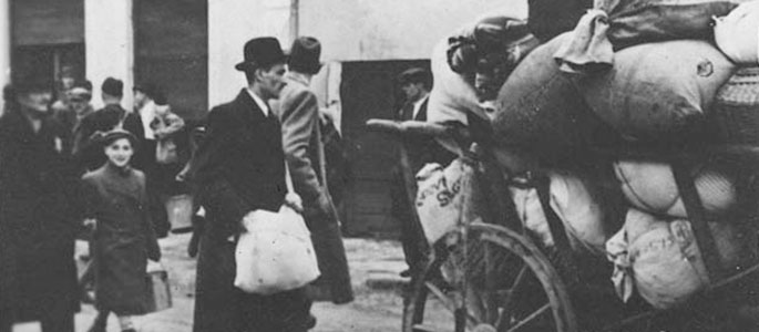 Jews walking next to carts loaded with their personal effects, being deported from Slovakia, 1942