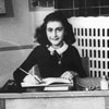 Anne Frank sitting at her desk, Amsterdam, 1940